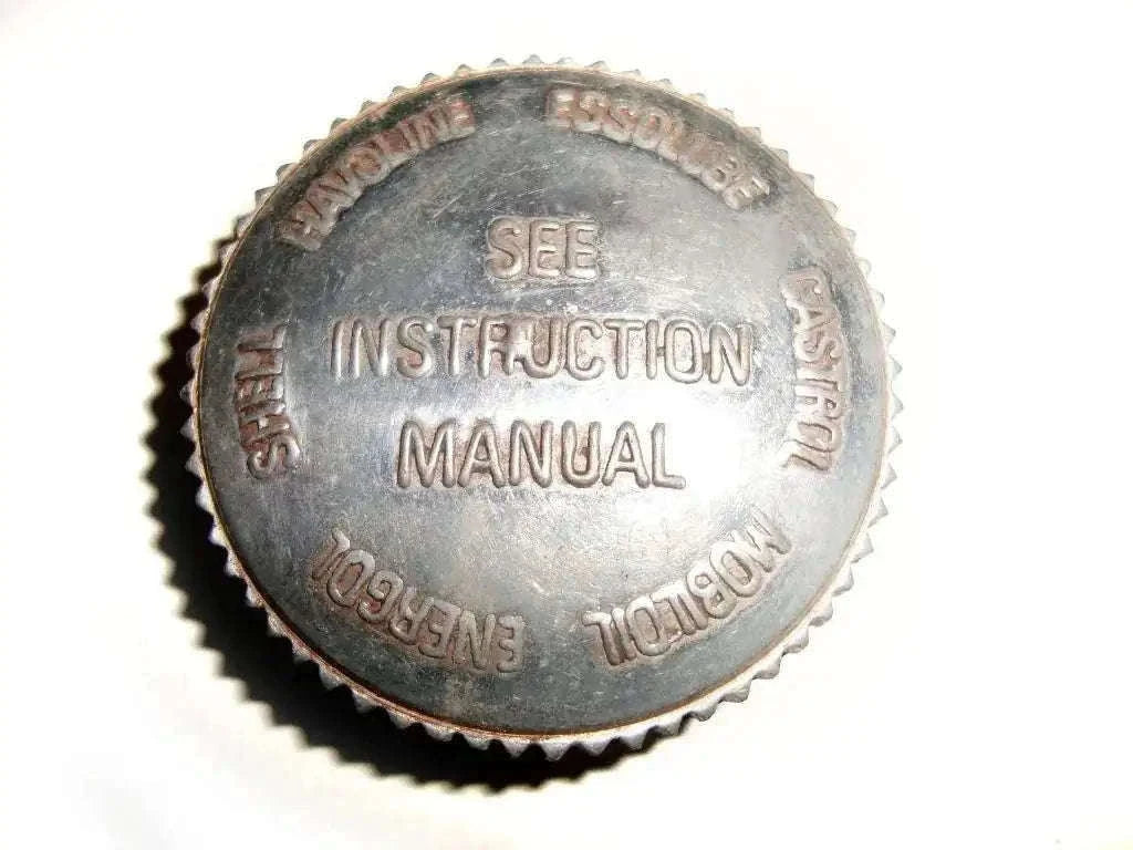 Metal oil tank filler cap with embossed text and serrated edge