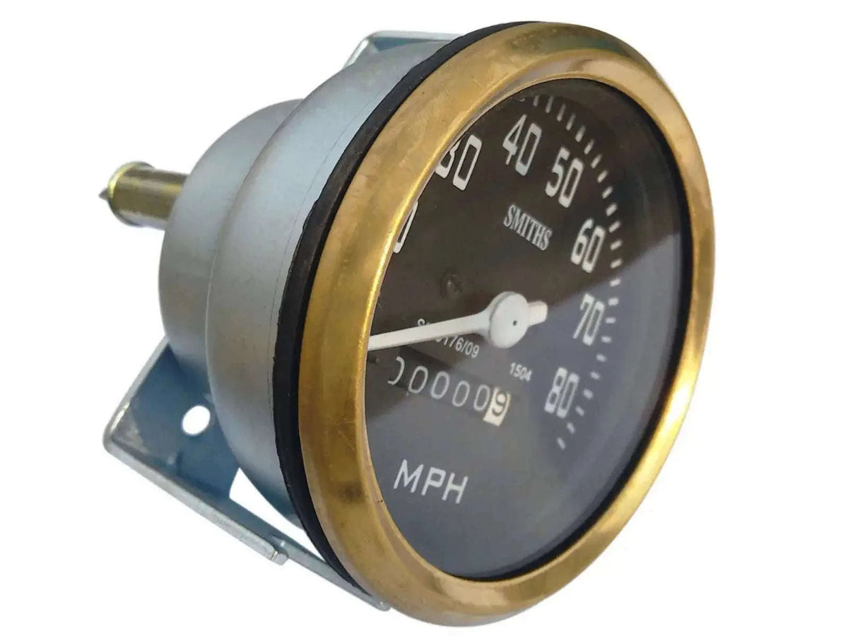 Round MPH speedometer with black face and brass bezel, Smiths logo and mounting bracket