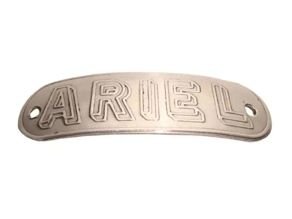 Metal tank badge with raised ARIEL lettering, oval shape, dark silver