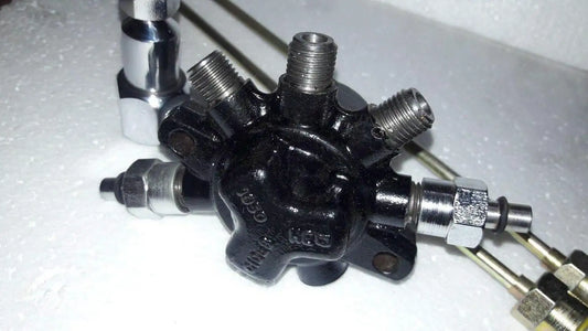 Dark fuel rail pump with metal fittings and threaded ports, high pressure pipe connections