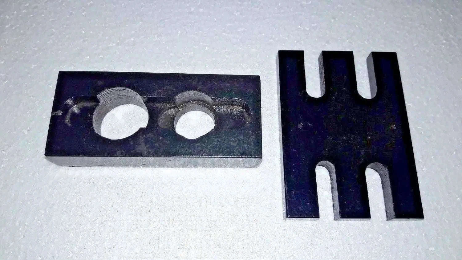 Metal injector adapter plate with two circular holes and forked holder prongs