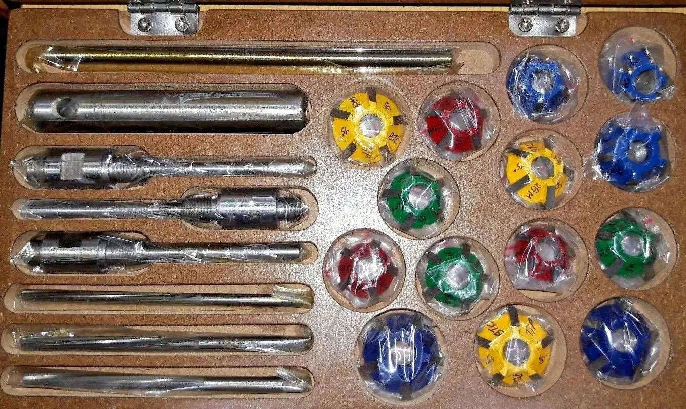 Valve seat cutter set with metal guide handle and colored carbide cutting tips in case