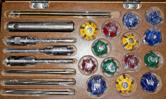 Valve seat cutter set with metal handle rods and colored carbide tip bits in tray