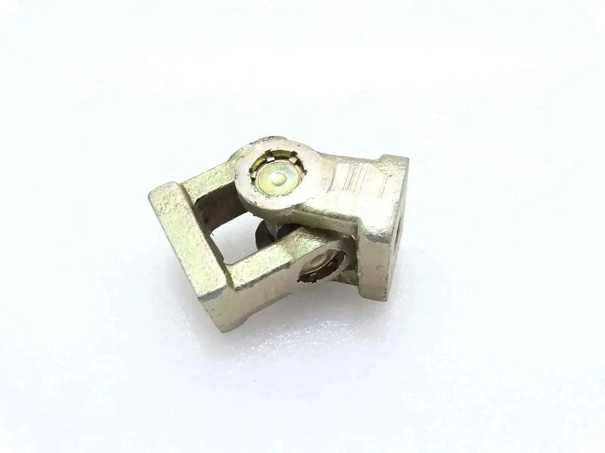Universal joint yoke with grease fitting, metal housing, for backhoe linkage