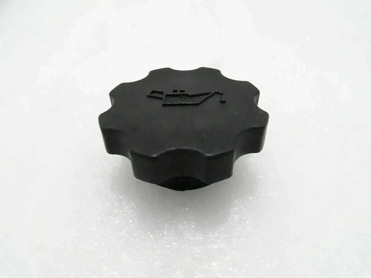 Black engine oil filler cap with ridged circular top and embossed pull tab