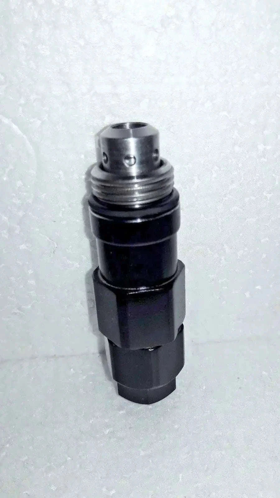 Hydraulic relief valve with silver metal top and black cylindrical body
