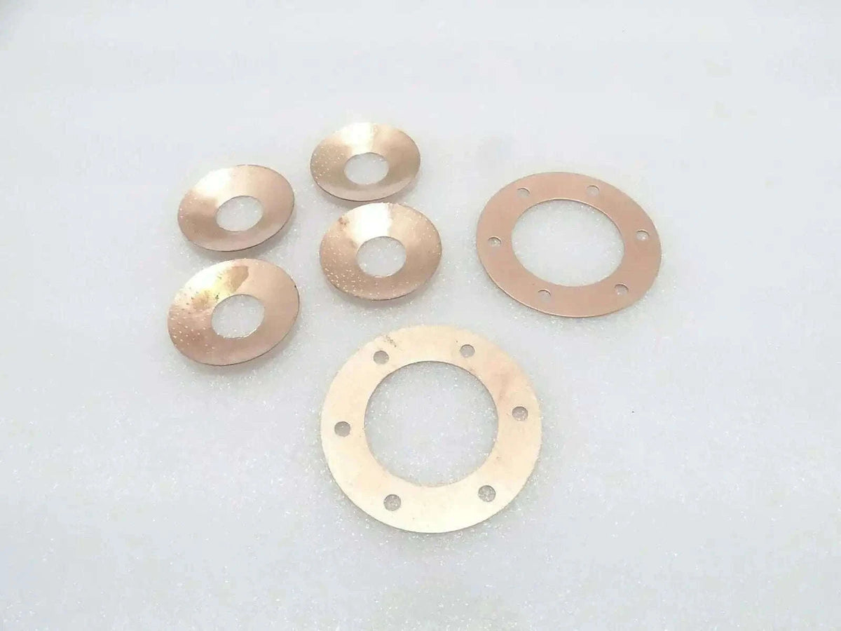 Metal thrust washers set with circular seal plates and center openings, copper-toned