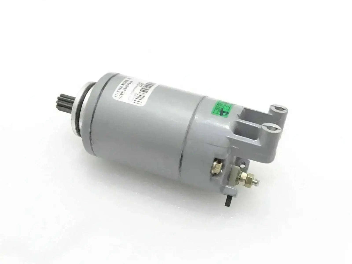 Starter motor assembly with cylindrical housing, gear, mounting bracket, and terminals