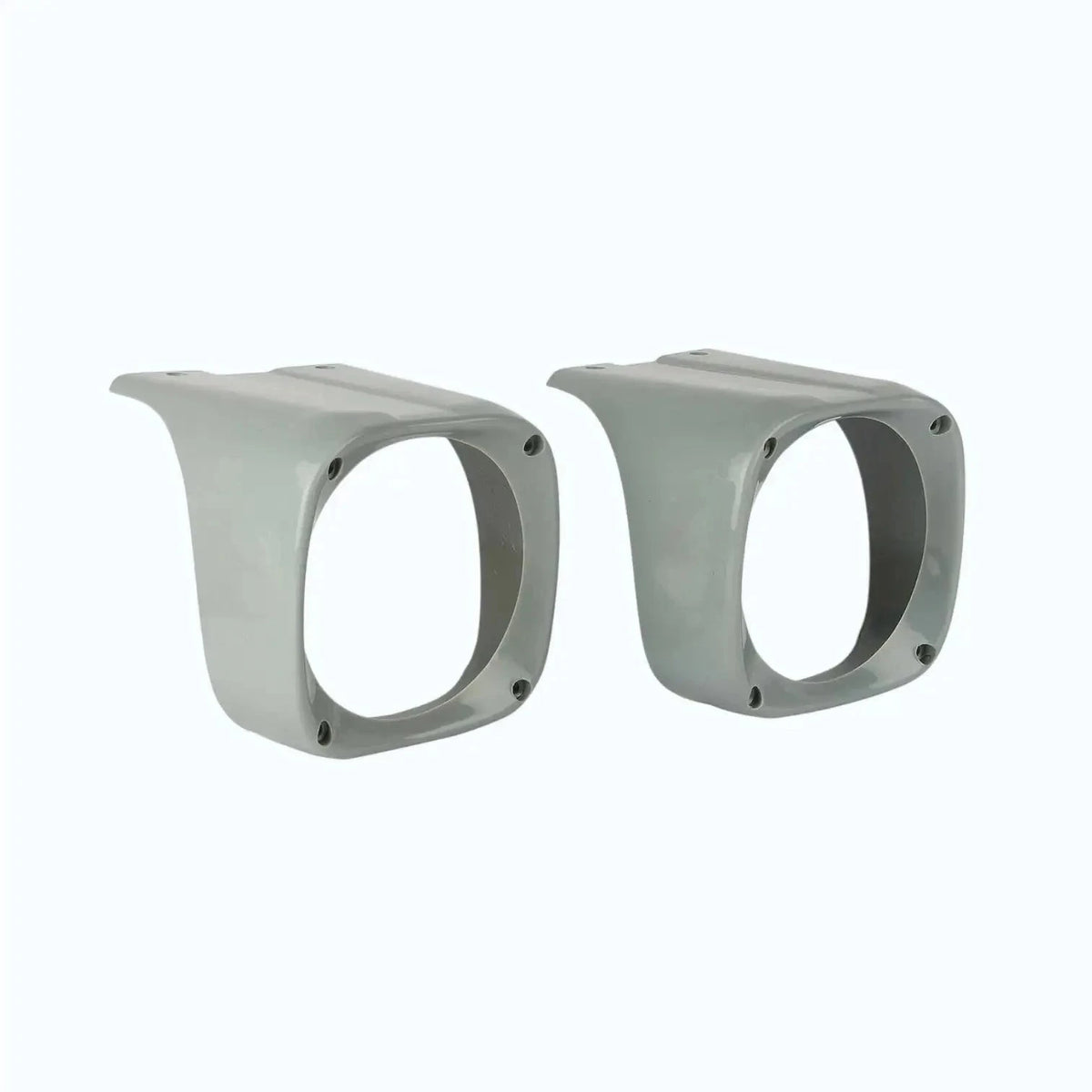 Pair of tractor headlight cowls with round openings and mounting screw holes