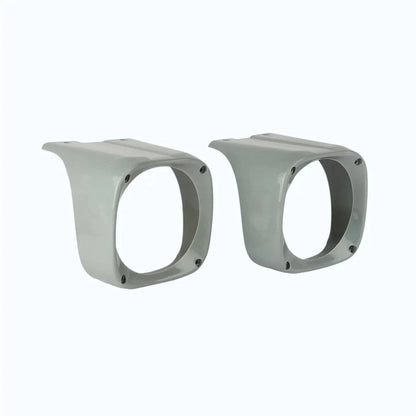 Pair of tractor headlight cowls with round openings and mounting screw holes