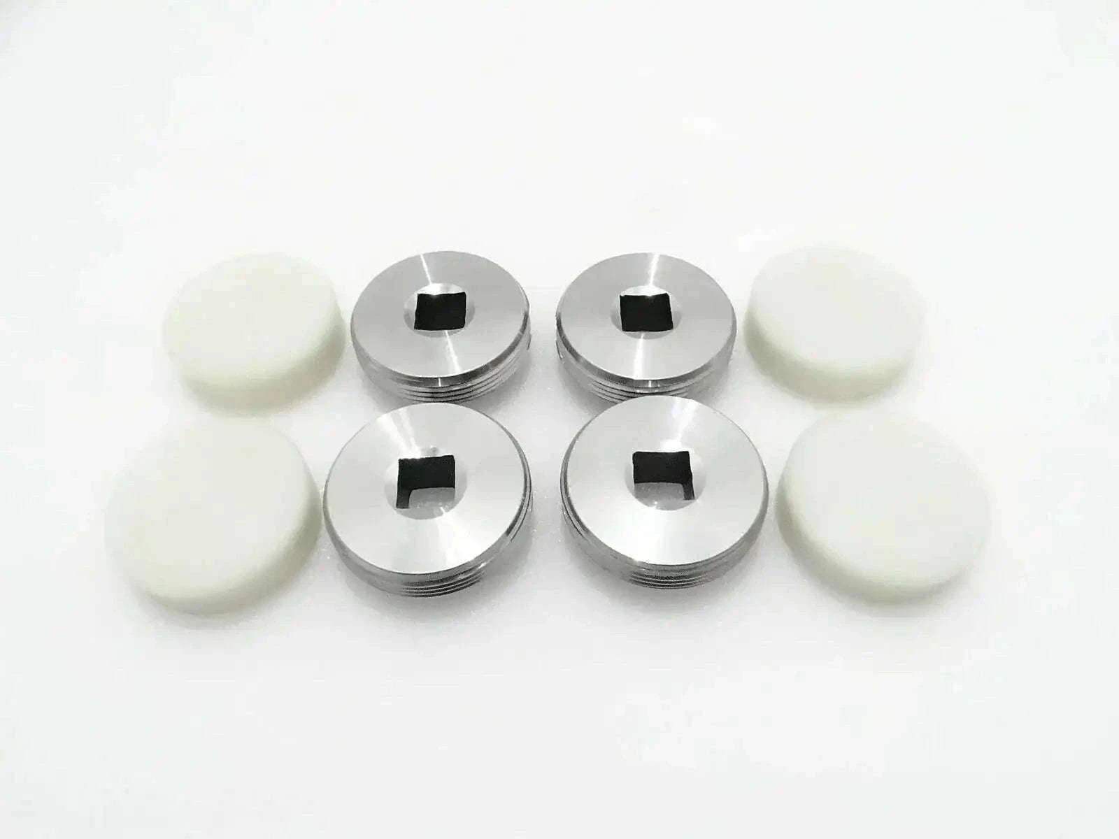 4-piece set of metal wear pads with black center and white rubber discs