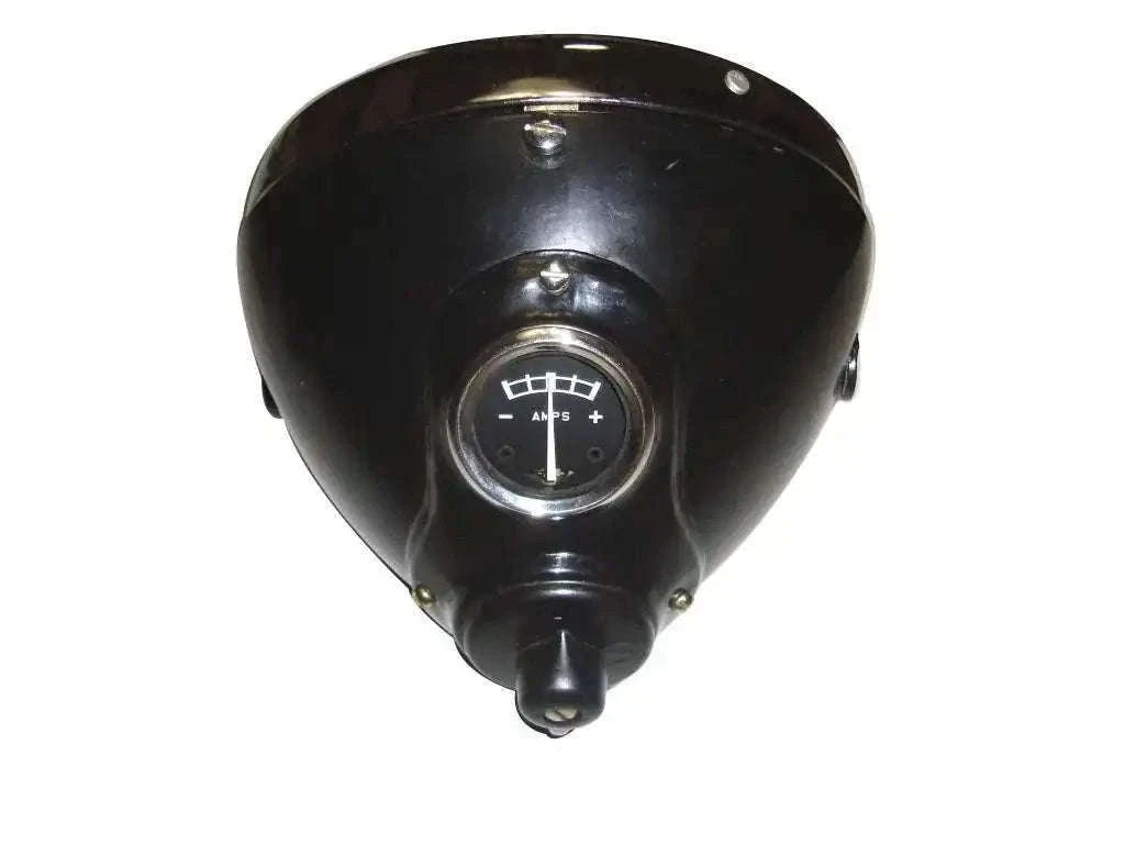 Black headlamp housing with circular lens and mounting bracket, triangular cover