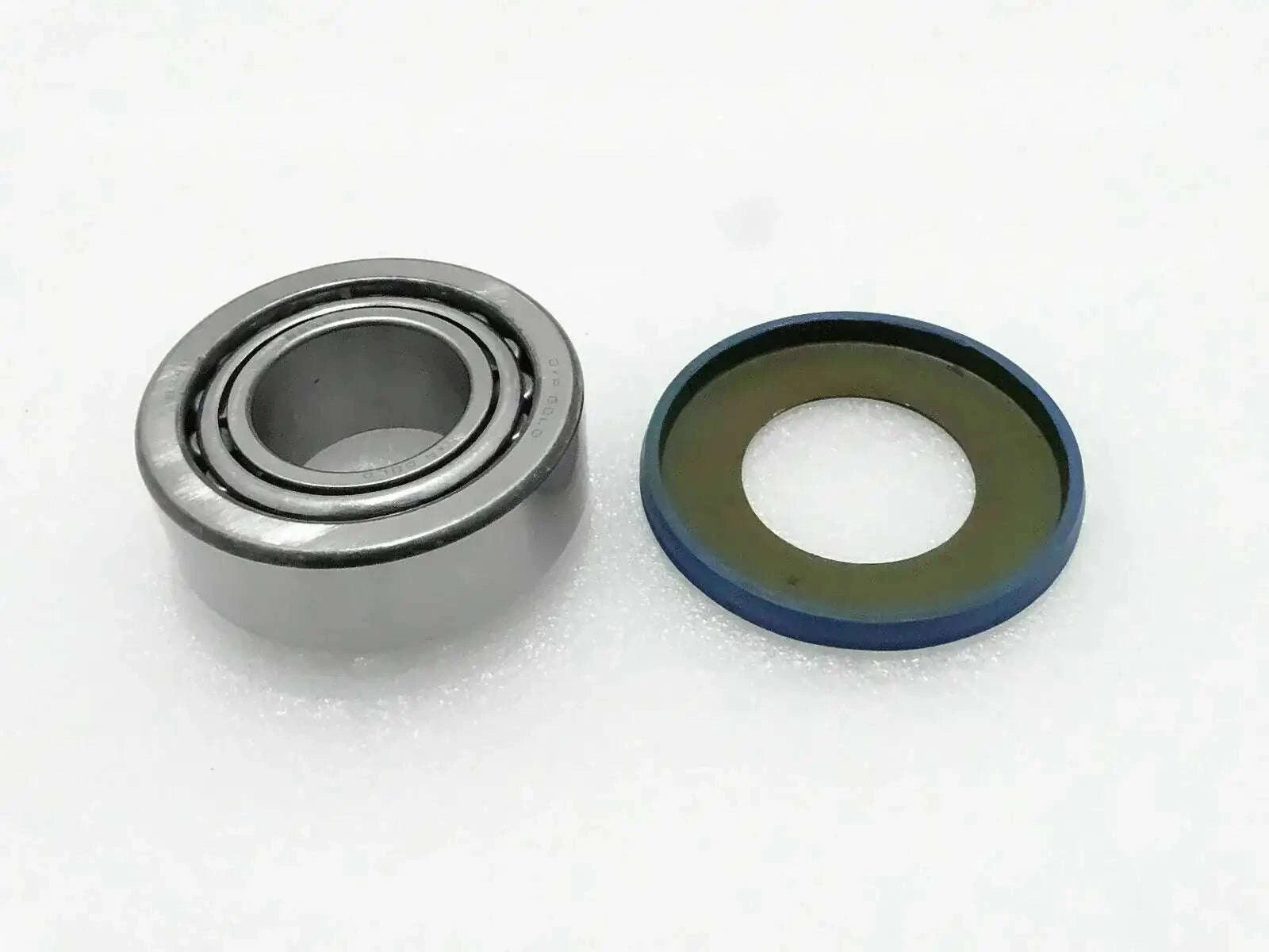 Steering knuckle trunnion bearing with seal ring, metal ball bearing and rubber seal