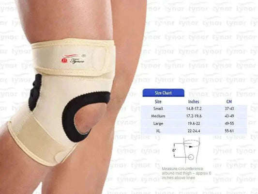 Beige neoprene knee support with front strap and black stabilizer, on leg