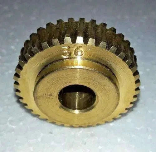 Brass worm gear with toothed ring and stamped 777 marking, metal finish