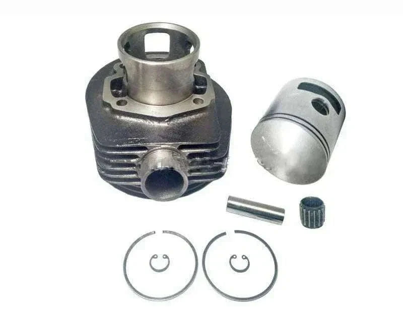 Cylinder piston kit components laid out: cylinder, piston, pin, and two piston rings