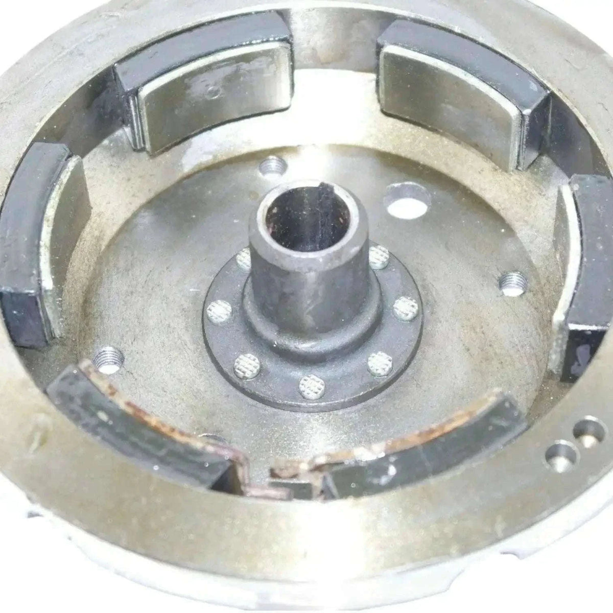 Metal flywheel housing with central hub and mounting points