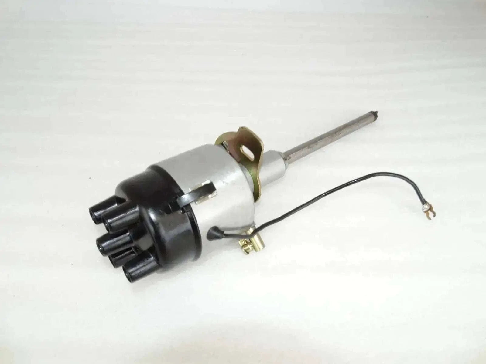 Complete distributor assembly with metal shaft, black housing, and wiring harness