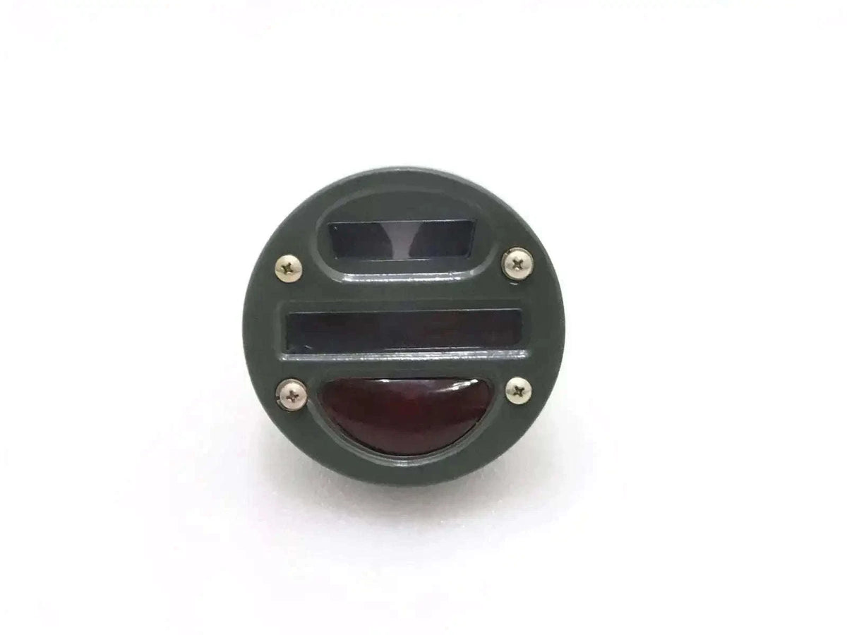 Round tail light cat-eye with clear top lens and red lower lens, black housing.