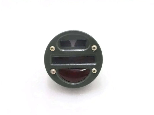 Round tail light cat-eye with clear top lens and red lower lens, black housing.